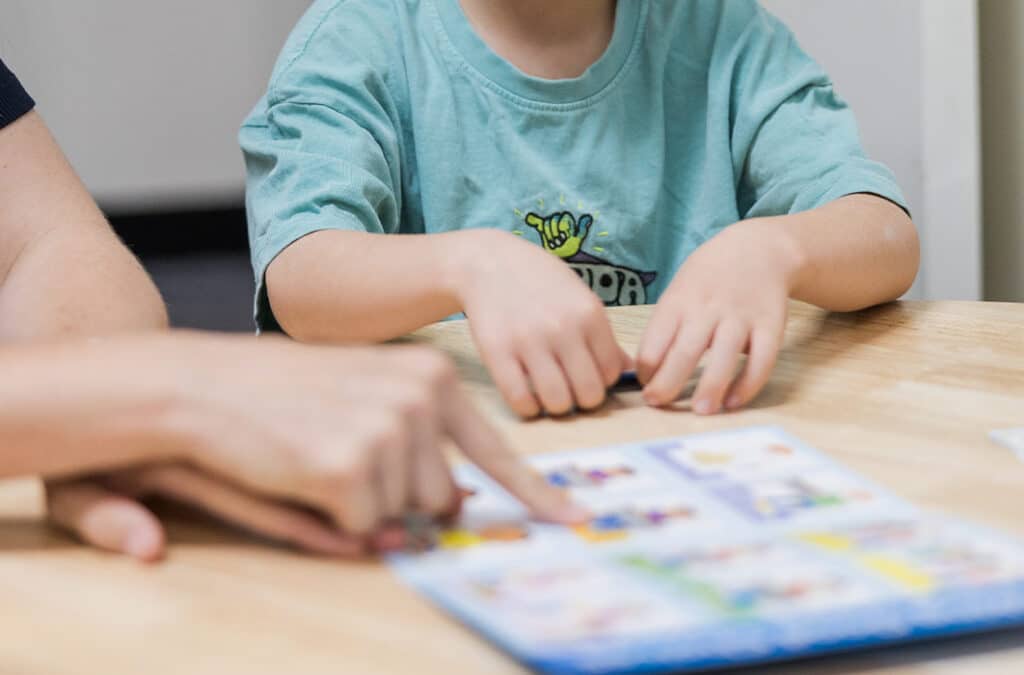 Paediatric therapist engaging children in a collaborative communication activity